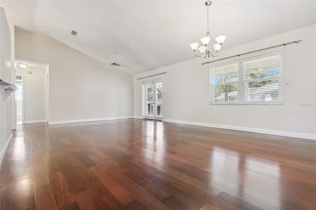a view of livingroom with chandelier fan and wooden floor
