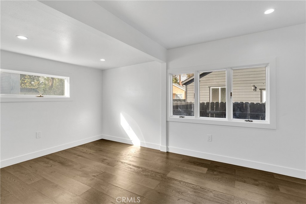 3635 Locust Street Riverside, CA 92501 - Photo 12 of 25 an empty room with wooden floor and windows