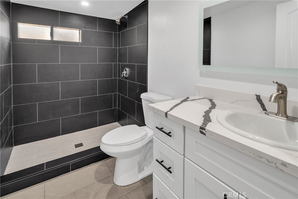 3635 Locust Street Riverside, CA 92501 - Photo 14 of 25 a bathroom with a sink toilet and shower