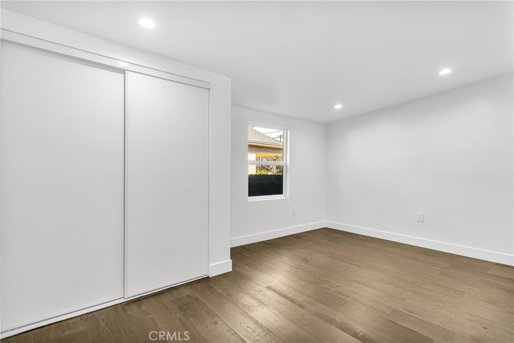 3635 Locust Street Riverside, CA 92501 - Photo 15 of 25 an empty room with wooden floor and windows