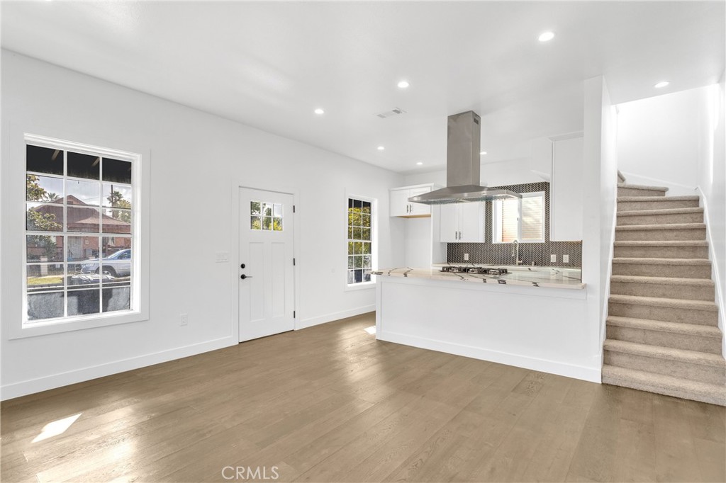 3635 Locust Street Riverside, CA 92501 - Photo 6 of 25 a view of a kitchen with a sink wooden cabinets and a window