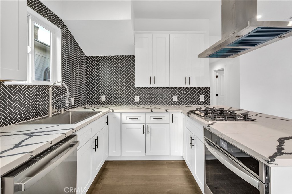 3635 Locust Street Riverside, CA 92501 - Photo 9 of 25 a kitchen with a sink stove and cabinets