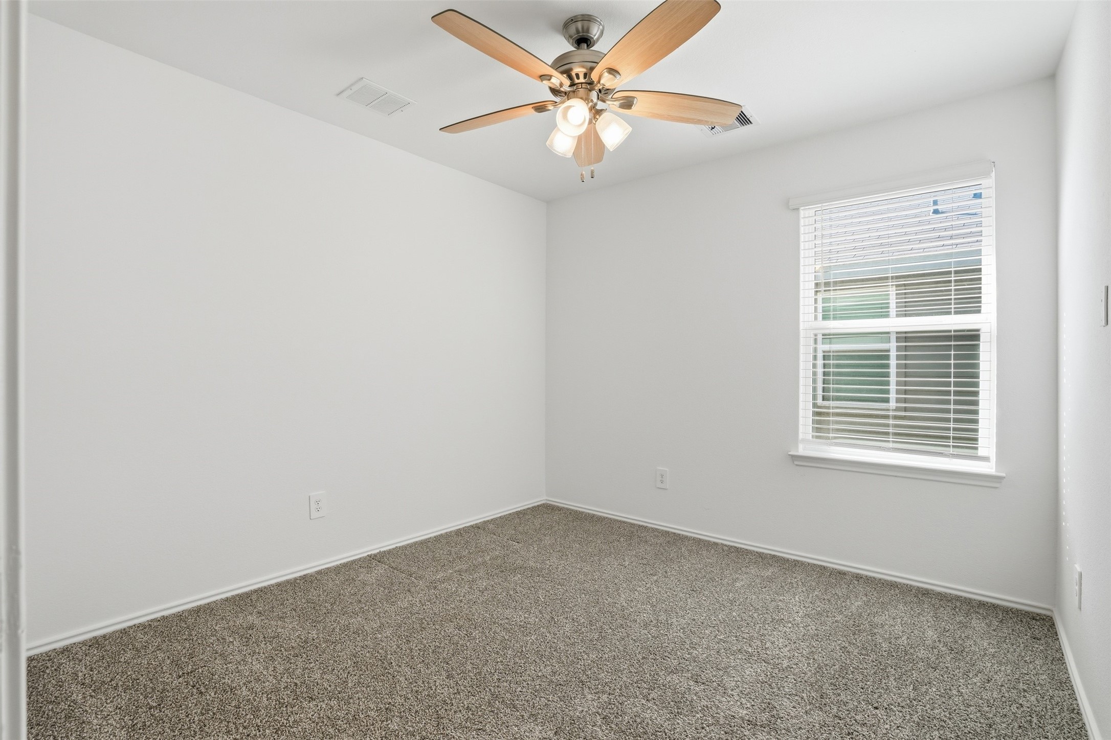 12214 Ridge River Lane Houston, TX 77067 - Photo 14 of 21 an empty room with a window and a fan