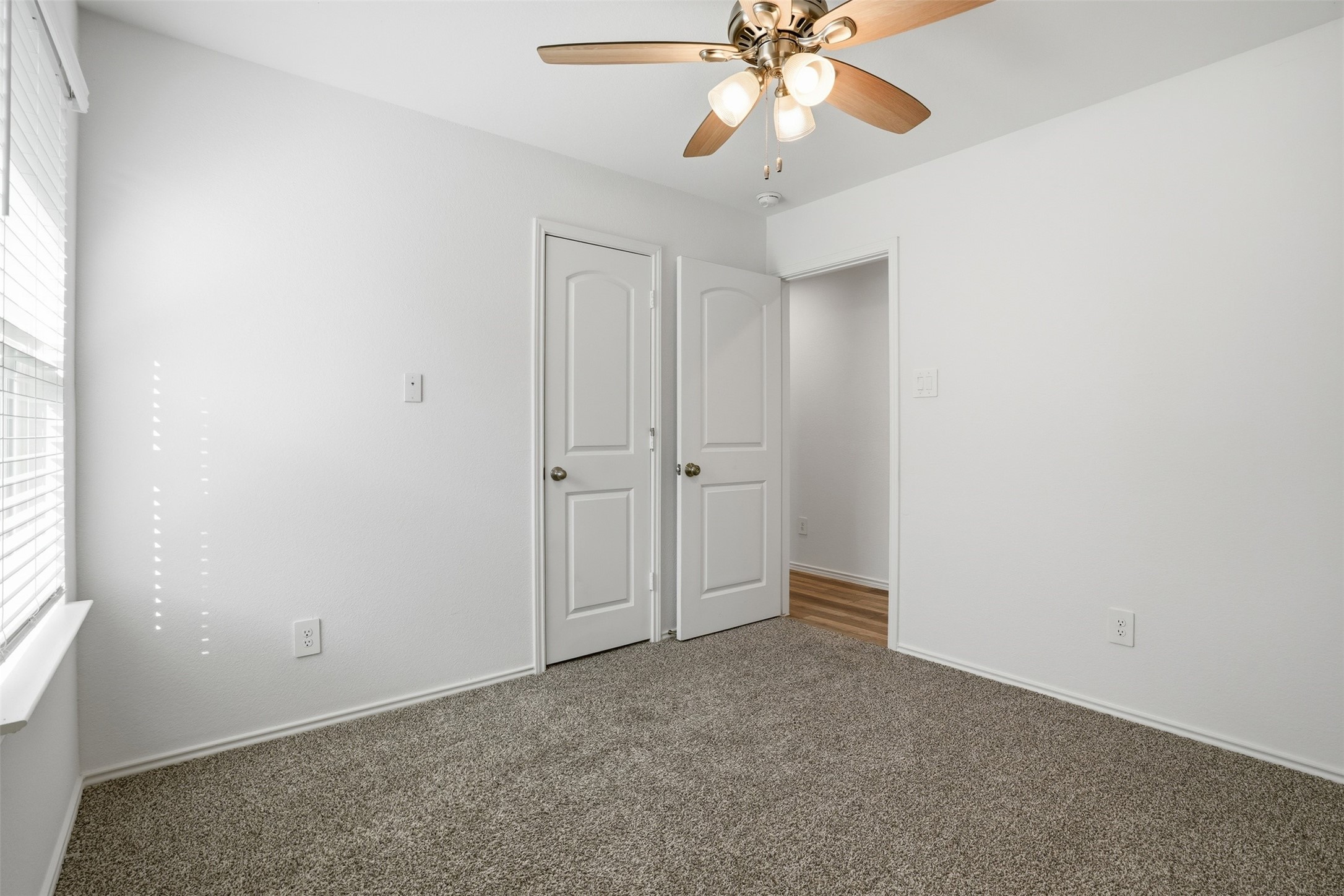 12214 Ridge River Lane Houston, TX 77067 - Photo 15 of 21 an empty room with a chandelier fan and windows