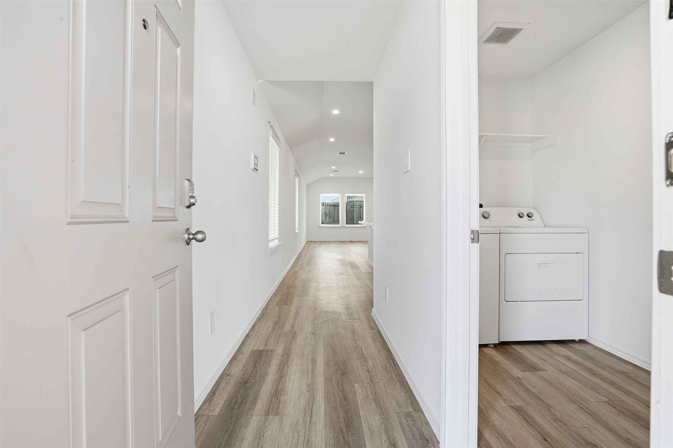 12214 Ridge River Lane Houston, TX 77067 - Photo 4 of 21 a view of a hallway with wooden floor and closet