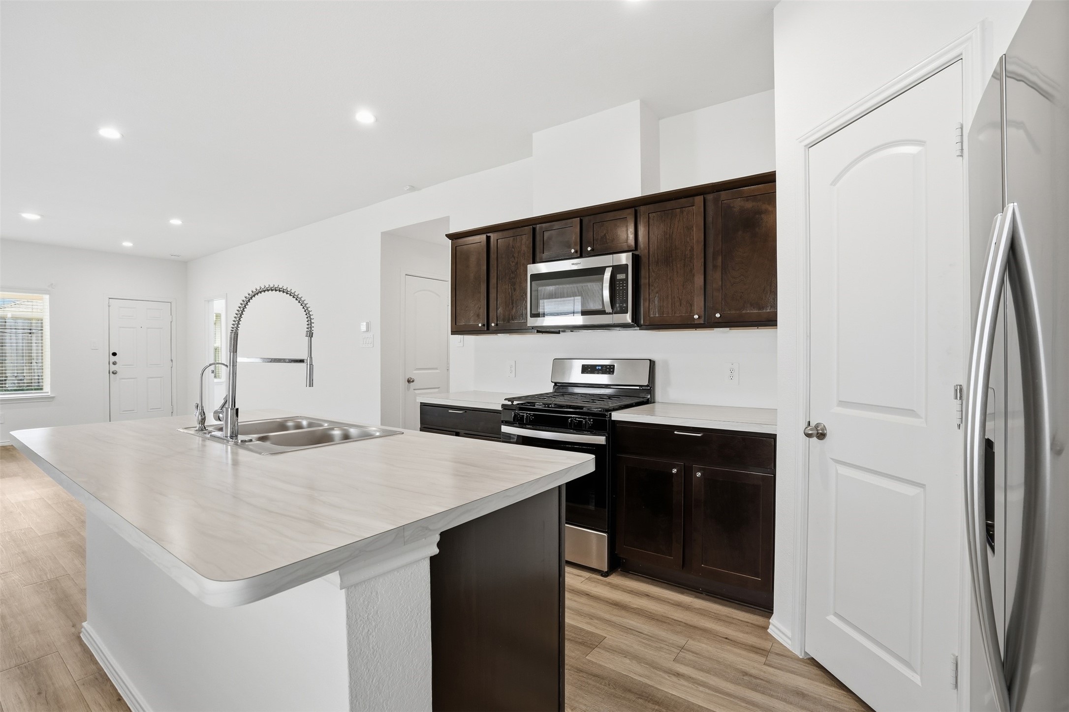 12214 Ridge River Lane Houston, TX 77067 - Photo 6 of 21 a kitchen with a sink appliances and cabinets