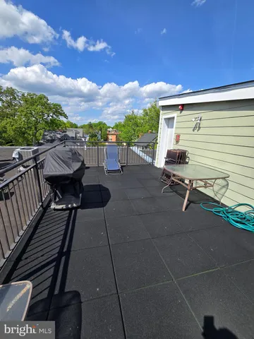 a terrace with outdoor seating and city view