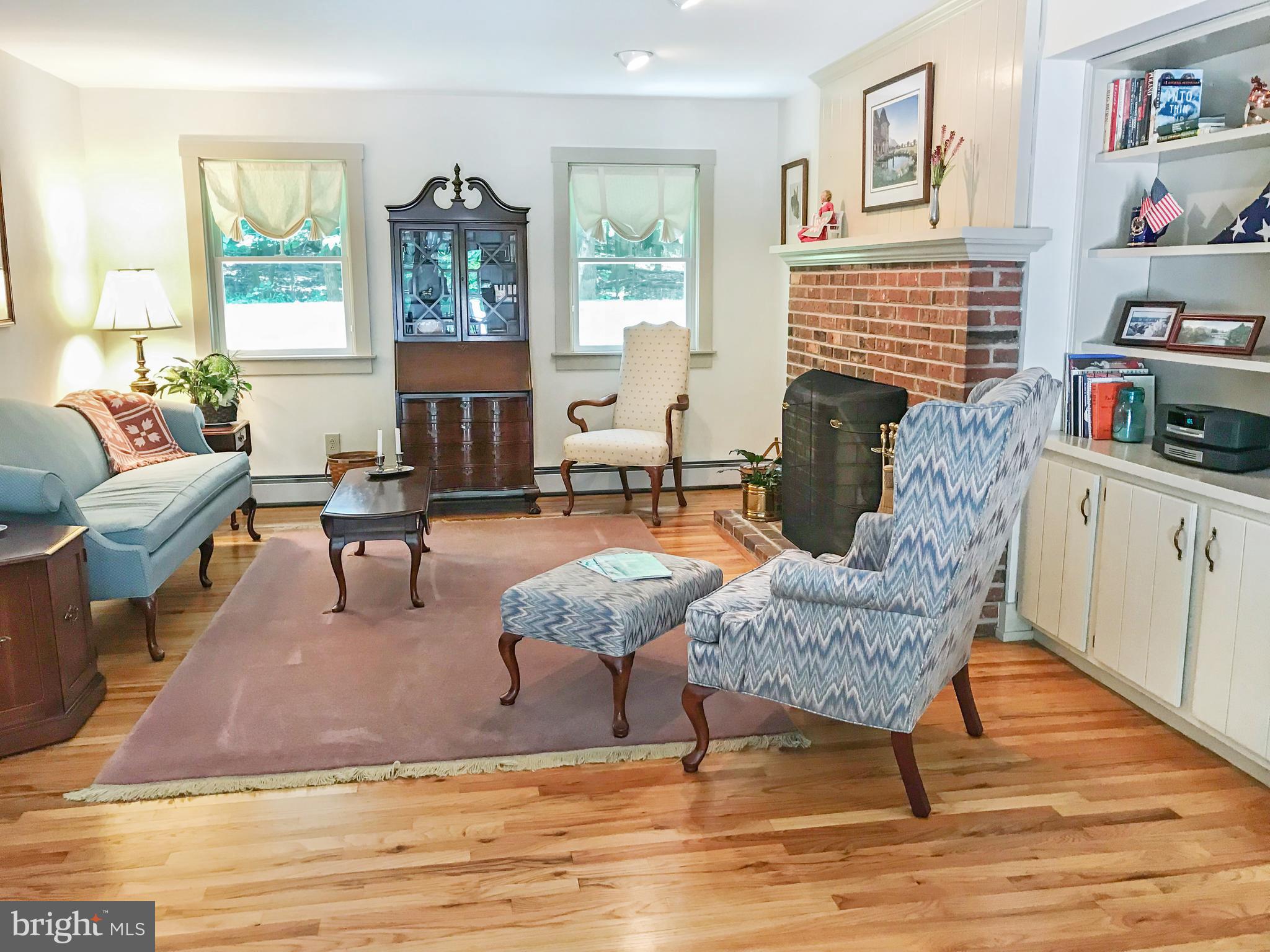Living Room - Brick Fireplace, Hardwood, Bookcases