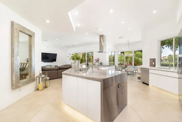 a bedroom with a bed flat screen tv and a large window