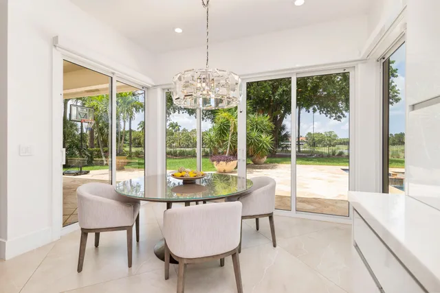 a dining room with furniture and large window
