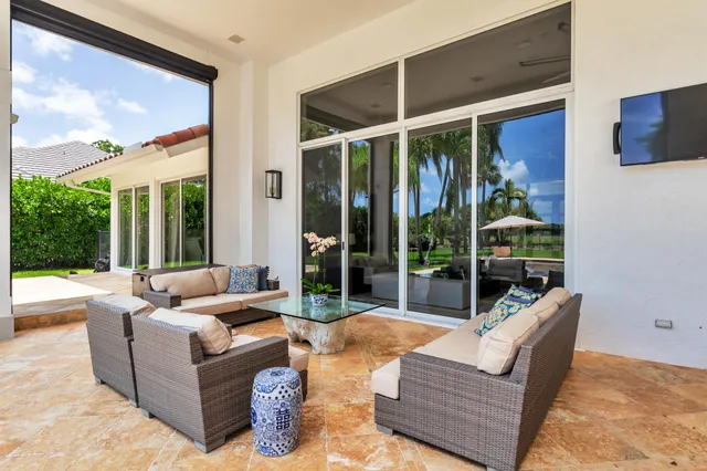 an aerial view of a house with yard swimming pool and outdoor seating