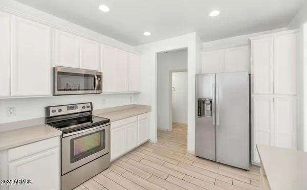 a kitchen with a refrigerator stove and microwave