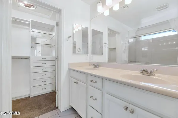a bathroom with a double vanity sink mirror and double