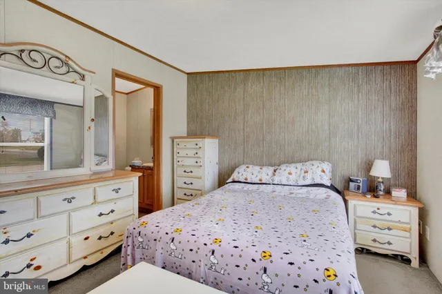 a bedroom with a bed and a dresser in it