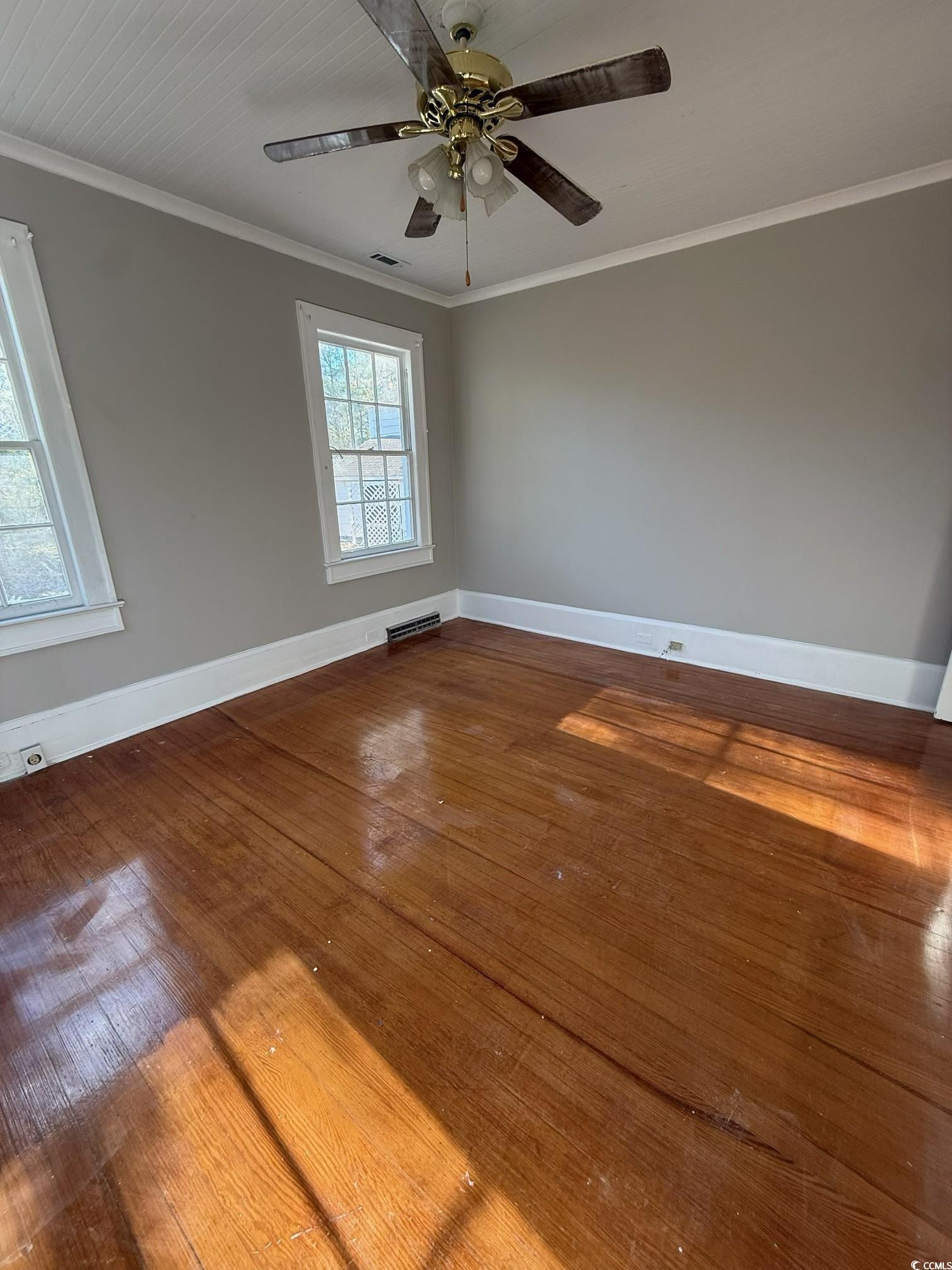 305 East Bamberg Street Latta, SC 29565 - Photo 4 of 13 Unfurnished room with ornamental molding and hardwood / wood-style floors