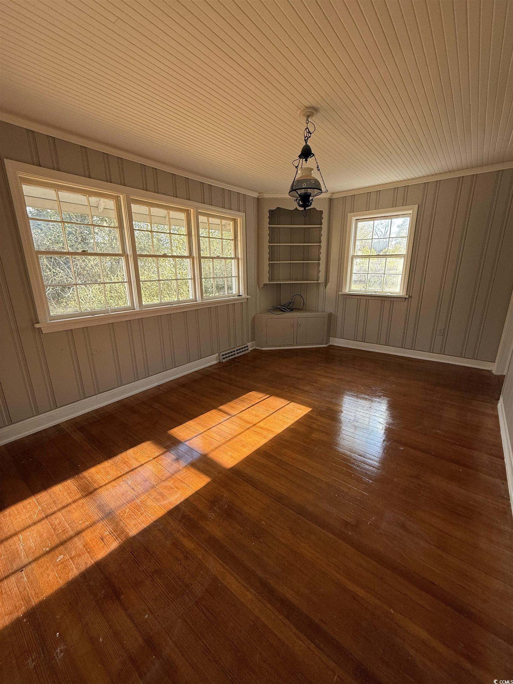 305 East Bamberg Street Latta, SC 29565 - Photo 7 of 13 Unfurnished living room with wood ceiling and dark wood-style floors