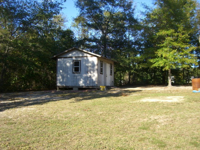 142 Whitaker Road Macon, GA 31211 - Photo 2 of 11 a view of a house with a yard and large tree