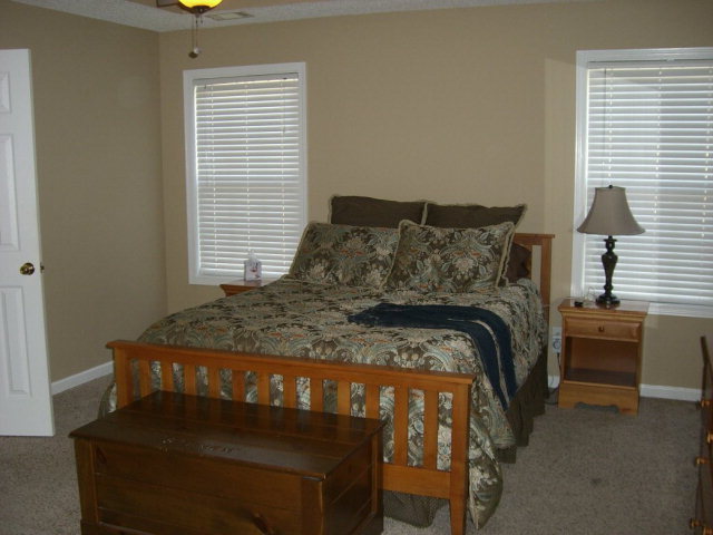 142 Whitaker Road Macon, GA 31211 - Photo 3 of 11 a bed sitting in a bedroom next to a window
