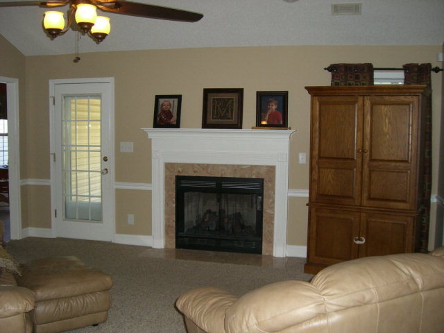 142 Whitaker Road Macon, GA 31211 - Photo 4 of 11 a living room with furniture and a fireplace