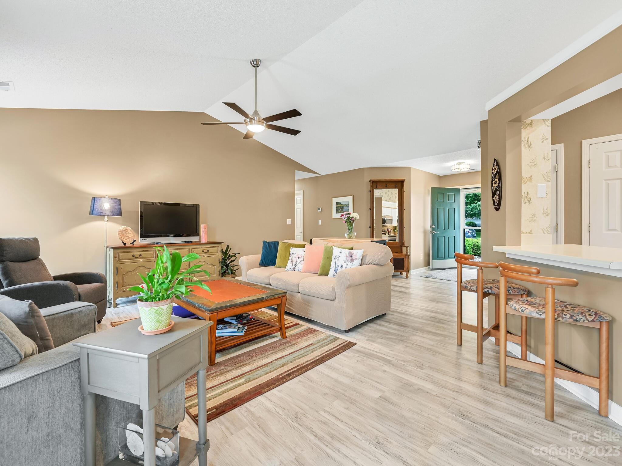 29 Stonehollow Road Fletcher, NC 28732 - Photo 5 of 21 a living room with furniture a flat screen tv and a dining table with wooden floor