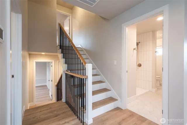 a view of a hallway with wooden floor and entryway