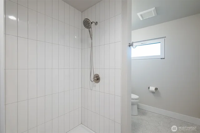 a bathroom with a toilet and shower