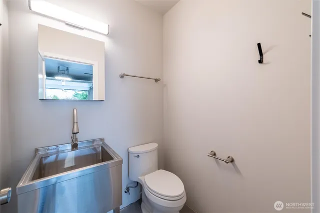 a white toilet sitting next to a bathroom sink