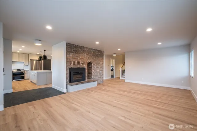 a view of a kitchen with a sink and a fireplace