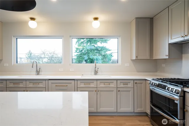 a kitchen with a sink cabinets and window