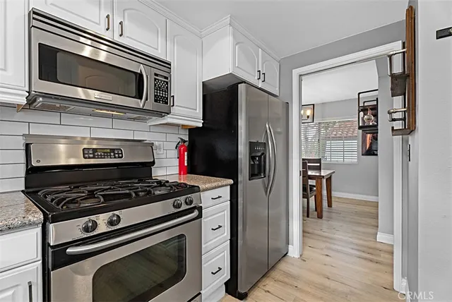 a kitchen with cabinets and steel stainless steel appliances