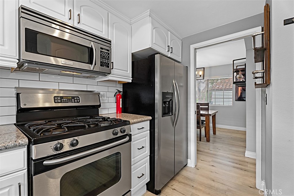 a kitchen with cabinets and steel stainless steel appliances