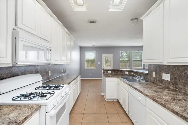 a kitchen with a stove a sink and a refrigerator