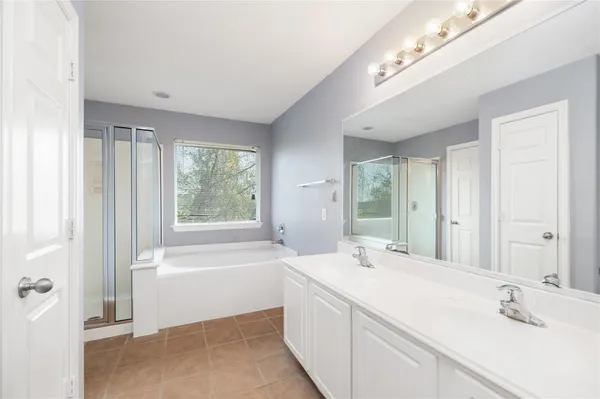 a bathroom with a bathtub a sink and a window