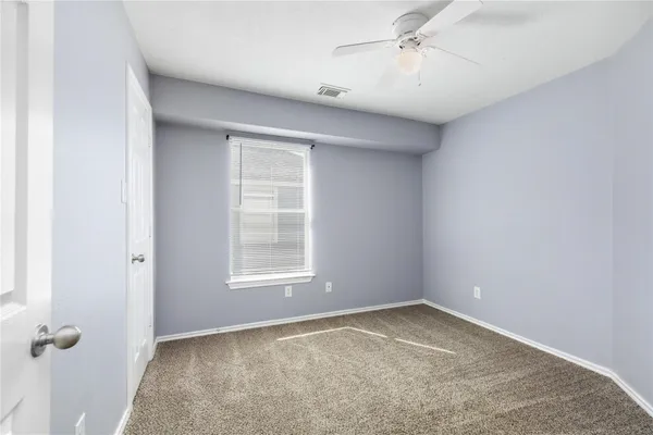 an empty room with a empty space and windows