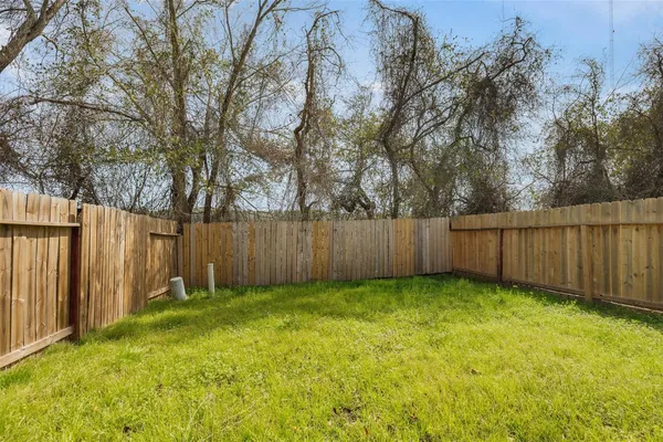 a view of a backyard with wooden fence