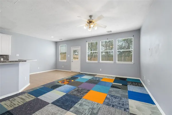 a living room with natural light and rug