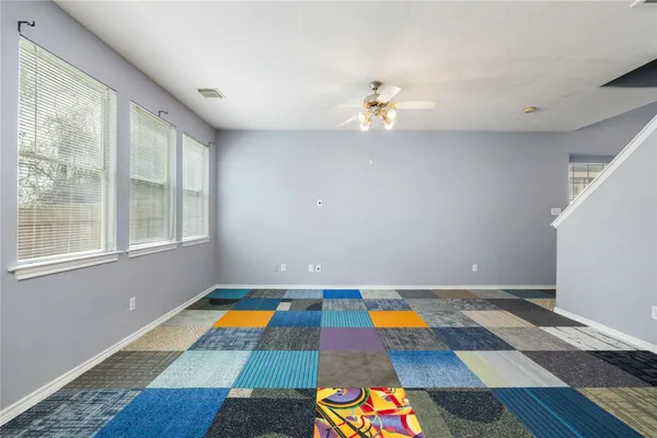 wooden floor with pool table and chandelier in a room