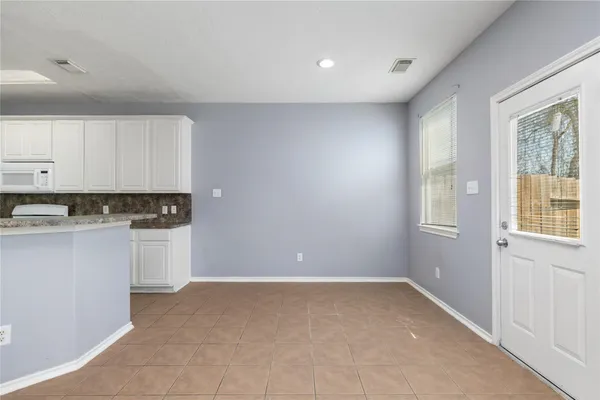 a view of a kitchen with dishwasher and cabinets