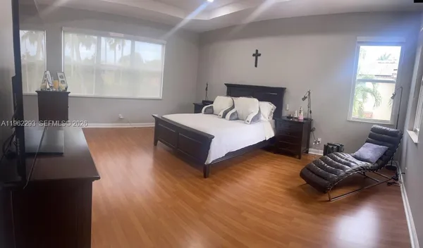 a spacious bedroom with a bed and window