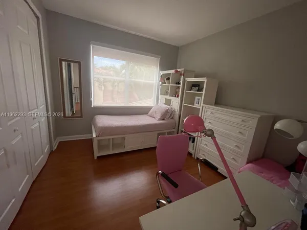 a bedroom with furniture and a window