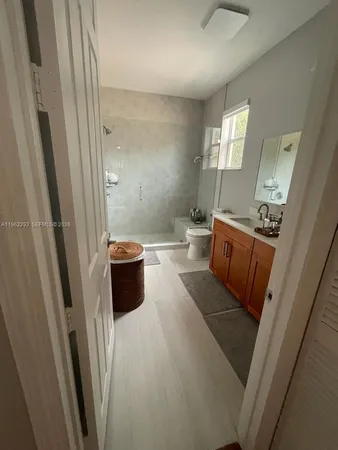 a view of a bathroom with tub and shower