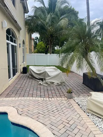 a view of a backyard with sitting area