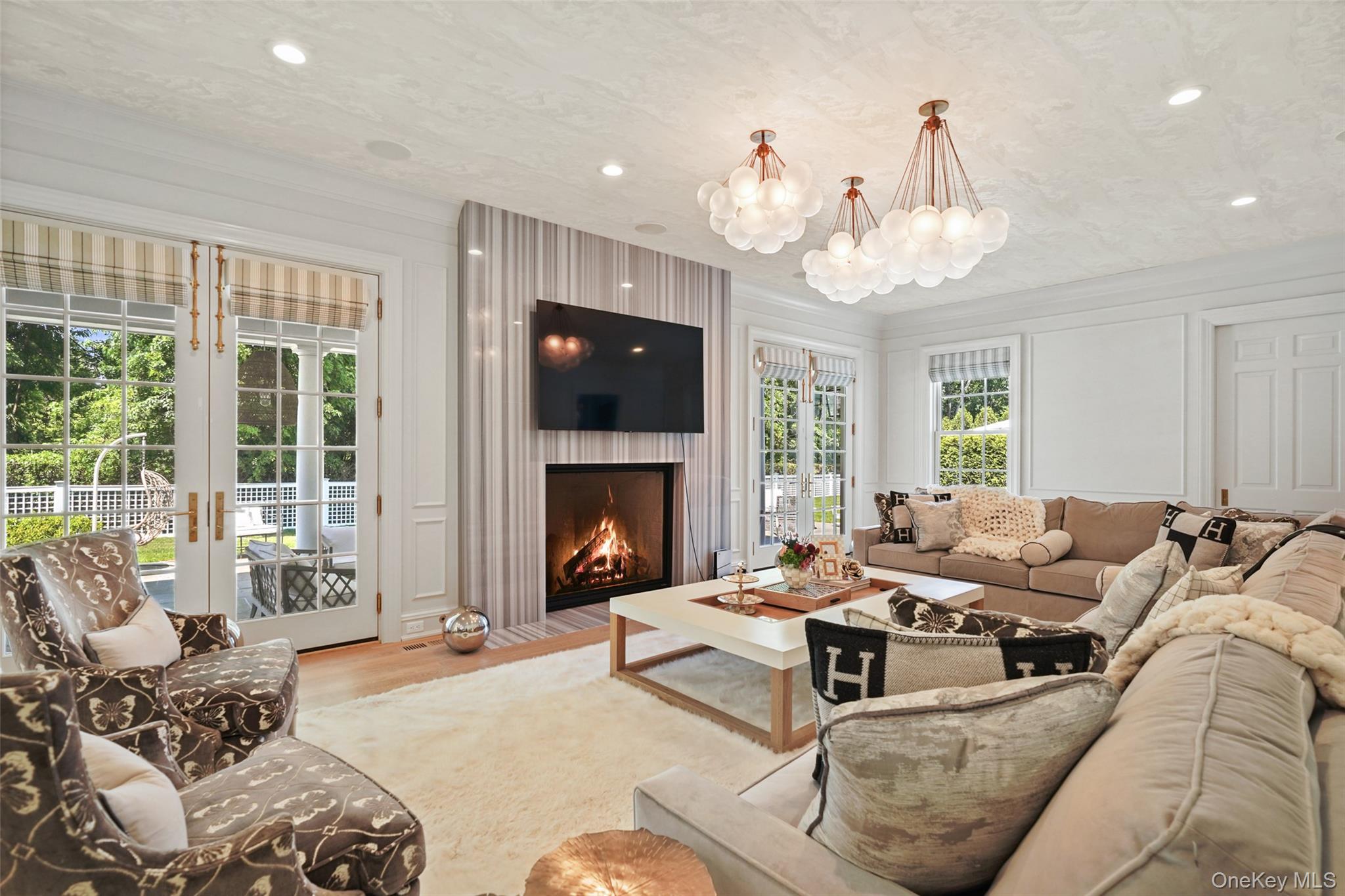 27 Murray Hill Road Scarsdale, NY 10583 - Photo 11 of 29 a living room with furniture a fireplace and a large window