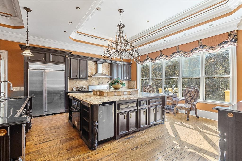 9830 Cedar Grove Road Fairburn, GA 30213 - Photo 16 of 55 a kitchen with stainless steel appliances granite countertop a stove and a refrigerator