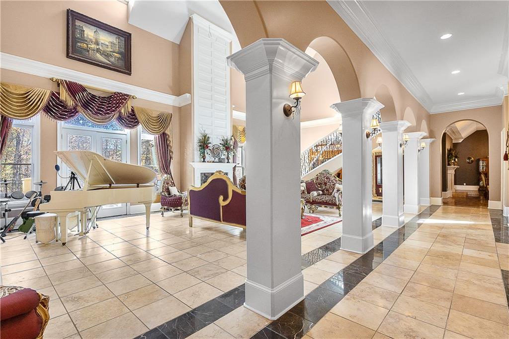 9830 Cedar Grove Road Fairburn, GA 30213 - Photo 20 of 55 a view of a hallway with dining area and chandelier