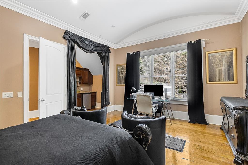 9830 Cedar Grove Road Fairburn, GA 30213 - Photo 34 of 55 a bedroom with a bed and wooden floor