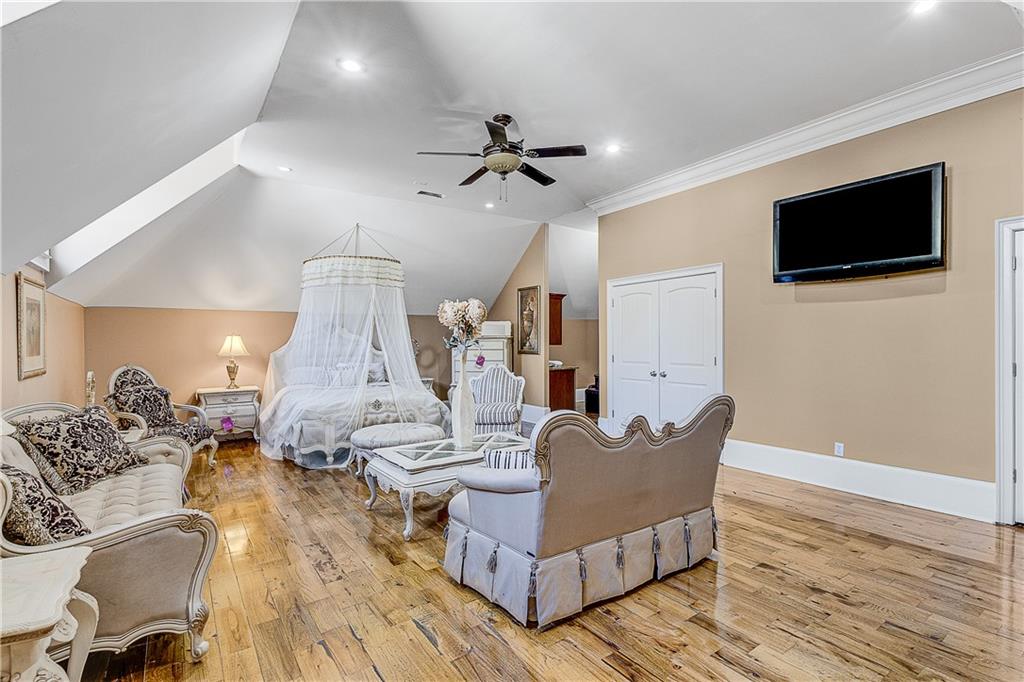 9830 Cedar Grove Road Fairburn, GA 30213 - Photo 40 of 55 a living room with furniture and a flat screen tv