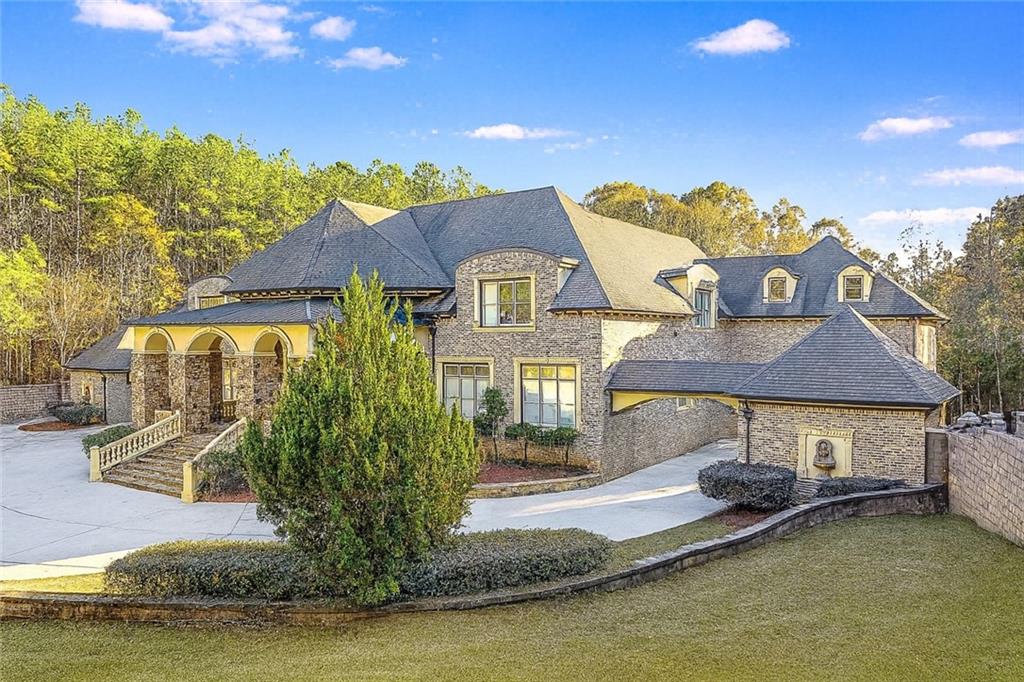 9830 Cedar Grove Road Fairburn, GA 30213 - Photo 4 of 55 a front view of a house with a yard and lake view