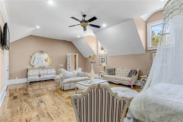 a living room with furniture a large window and a potted plant