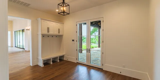 a view of a hallway with wooden floor